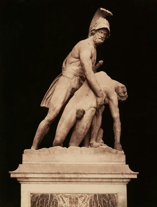 A greek statue depicts two men in conflict.